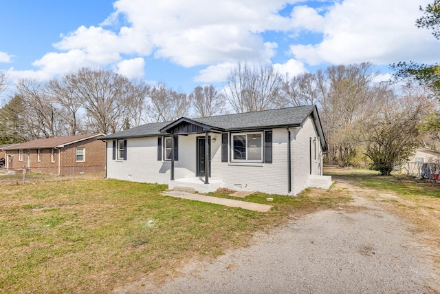 view of front facade featuring brick siding, a shingled roof, fence, a front yard, and crawl space