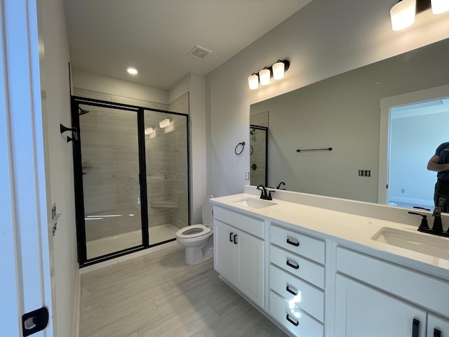 full bath featuring a shower stall, toilet, and a sink