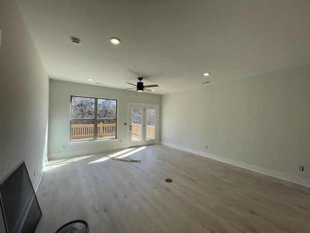 unfurnished living room featuring ceiling fan, baseboards, wood finished floors, and recessed lighting