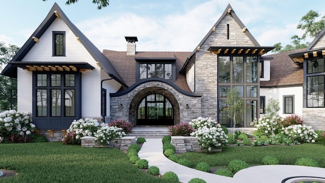 view of front of property with stone siding, french doors, a chimney, and a front yard