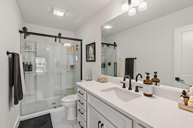 bathroom featuring tile patterned floors, toilet, a stall shower, and vanity