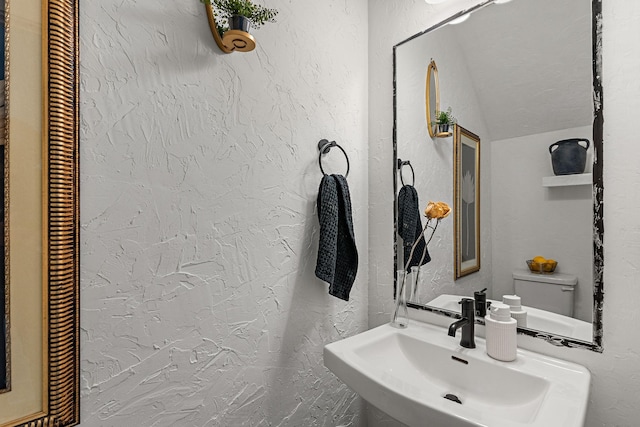 bathroom with a sink and a textured wall