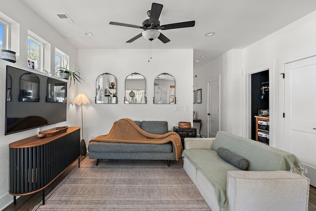 living area with visible vents, recessed lighting, ceiling fan, and wood finished floors