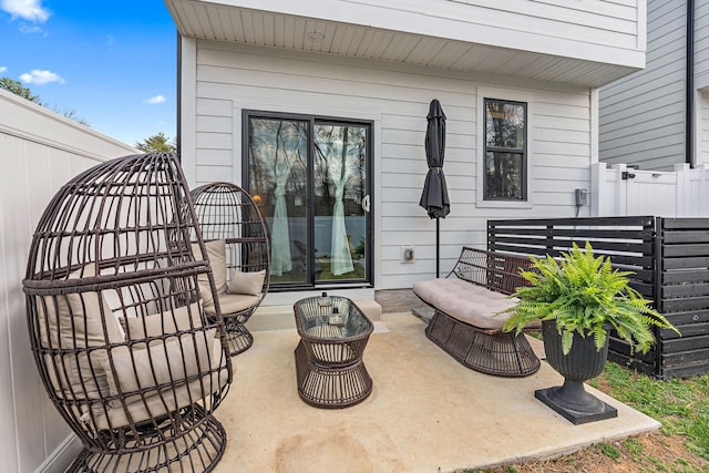 view of patio / terrace featuring an outdoor living space and fence