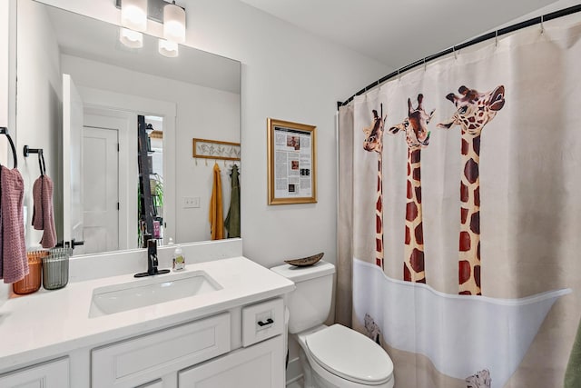 full bathroom with vanity, curtained shower, and toilet