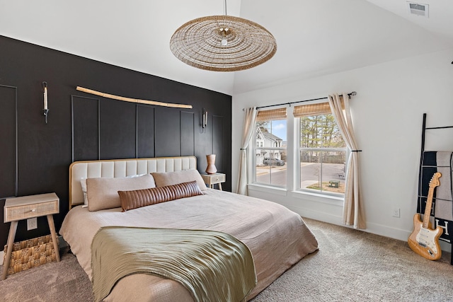 bedroom featuring visible vents, baseboards, lofted ceiling, and carpet