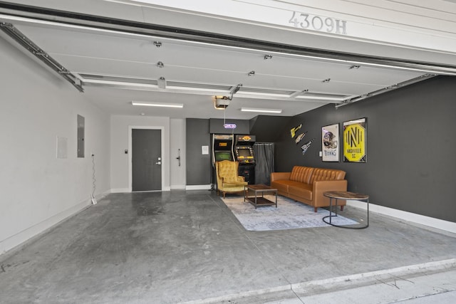 garage with electric panel, a garage door opener, and baseboards