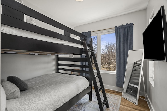 bedroom with wood finished floors and baseboards