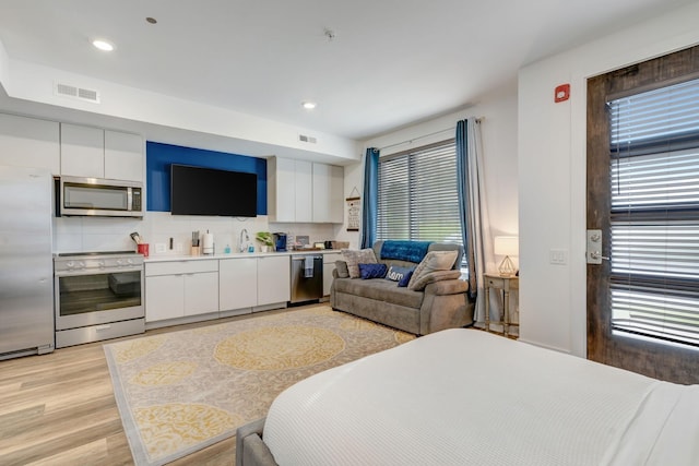 interior space featuring recessed lighting, visible vents, and light wood-style flooring