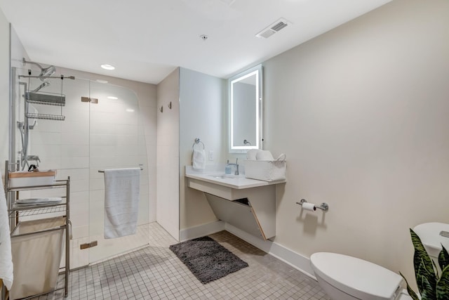 bathroom with a tile shower, visible vents, tile patterned flooring, and toilet