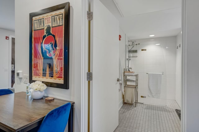 bathroom with tile patterned floors, vanity, and a tile shower