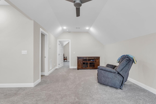 living area featuring vaulted ceiling, carpet, baseboards, and ceiling fan