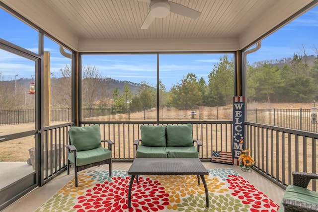 sunroom / solarium with a wealth of natural light and ceiling fan