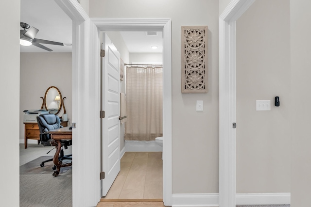 hall featuring baseboards