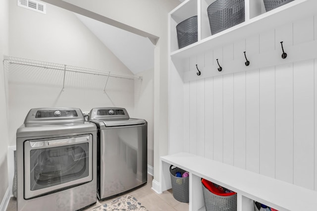 laundry area with laundry area, visible vents, and washing machine and clothes dryer