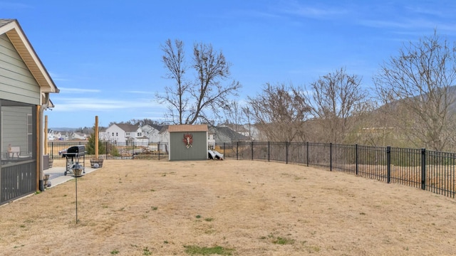 view of yard featuring a patio, an outdoor structure, a storage shed, and a fenced backyard