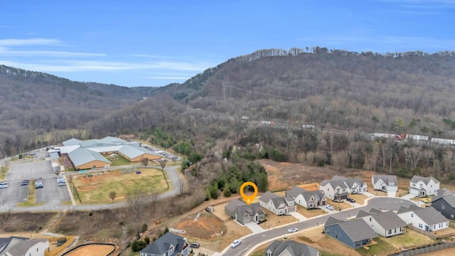 drone / aerial view with a mountain view, a forest view, and a residential view