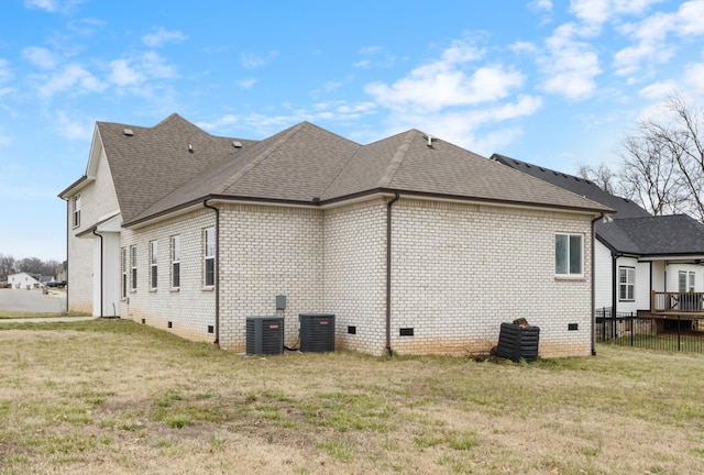 view of home's exterior featuring crawl space, a lawn, and roof with shingles