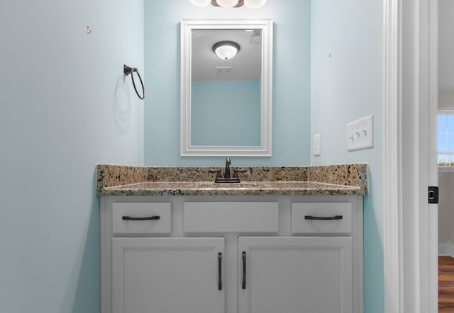 bathroom with vanity, wood finished floors, and visible vents