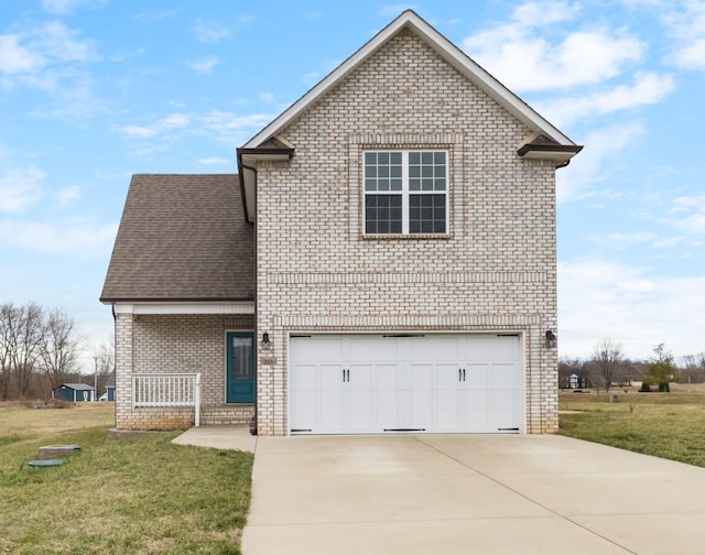 traditional-style house featuring driveway, roof with shingles, an attached garage, a front yard, and brick siding