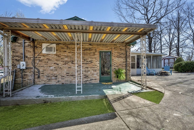 exterior space featuring a patio and brick siding