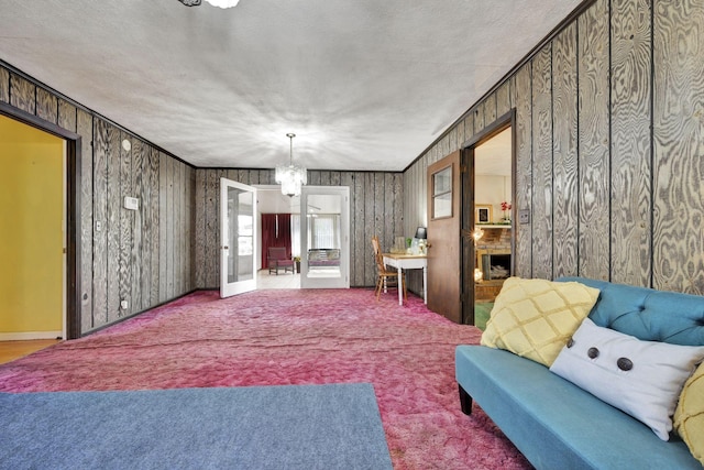 living room featuring carpet and a chandelier