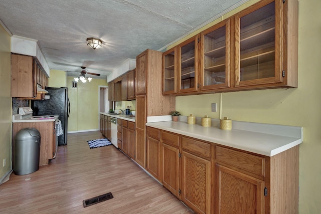 kitchen with visible vents, light wood-style flooring, light countertops, dishwasher, and ceiling fan