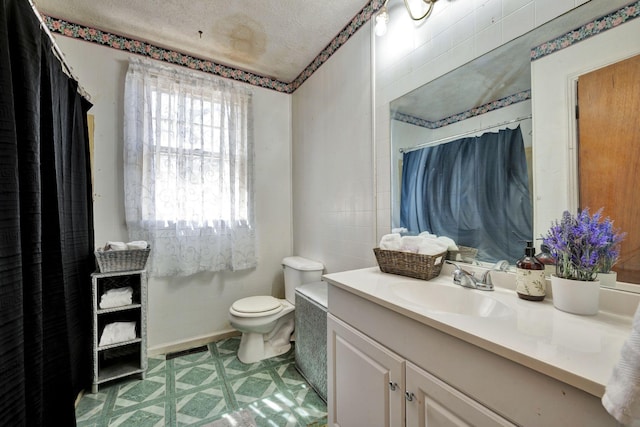 full bath featuring curtained shower, toilet, vanity, a textured ceiling, and tile walls