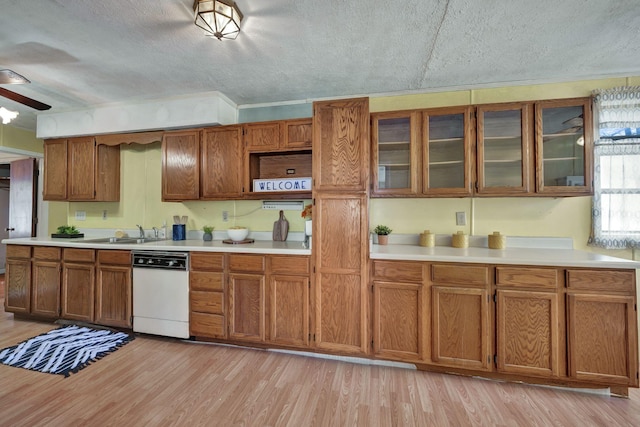 kitchen with a sink, light wood-style floors, and brown cabinetry