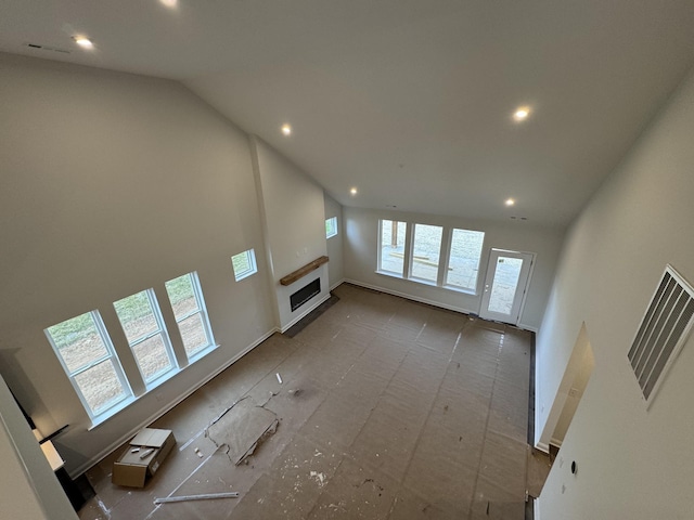 unfurnished living room featuring recessed lighting, visible vents, a fireplace, and vaulted ceiling