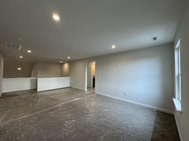 spare room with recessed lighting, visible vents, and baseboards