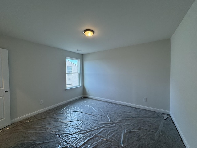 spare room with visible vents and baseboards