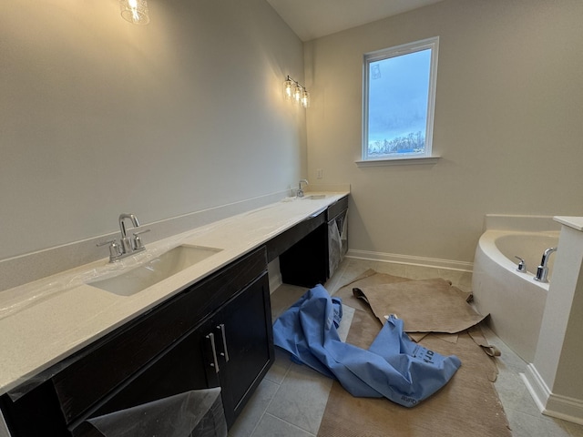 full bathroom featuring double vanity, baseboards, and a sink