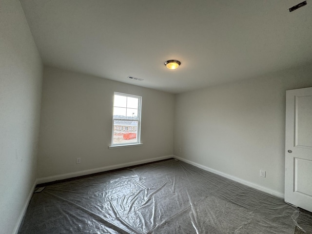 unfurnished room with visible vents and baseboards