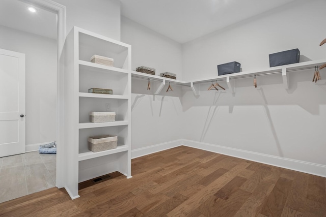 spacious closet with wood finished floors