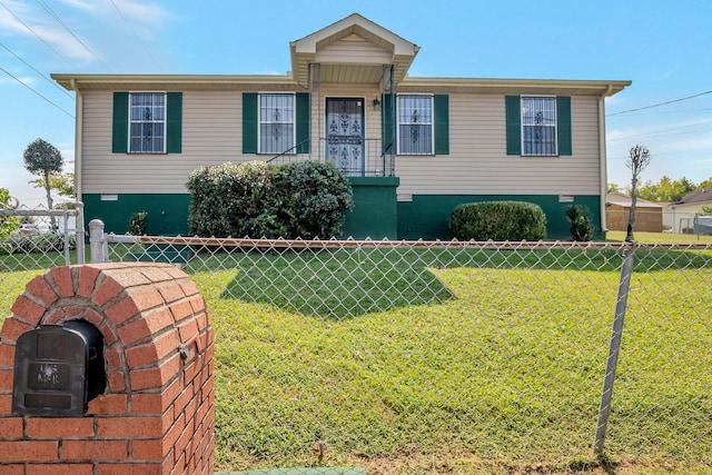 view of front of house with a front lawn and fence