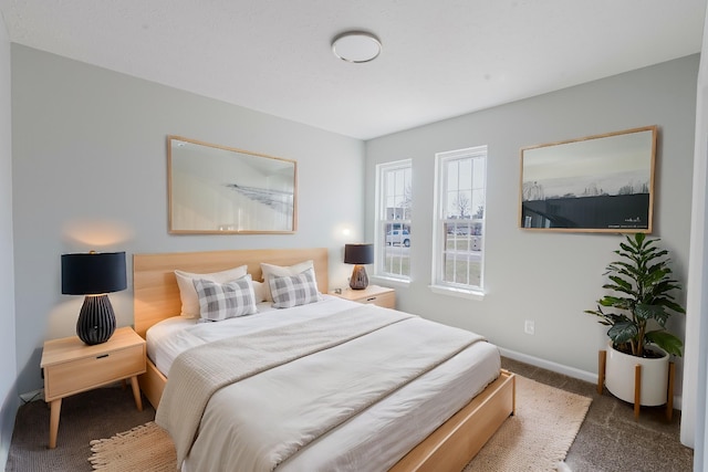 bedroom with baseboards and carpet floors