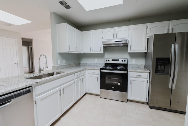 kitchen featuring visible vents, under cabinet range hood, a sink, stainless steel appliances, and a skylight