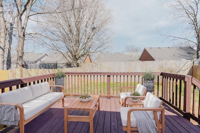 deck with an outdoor living space and a fenced backyard