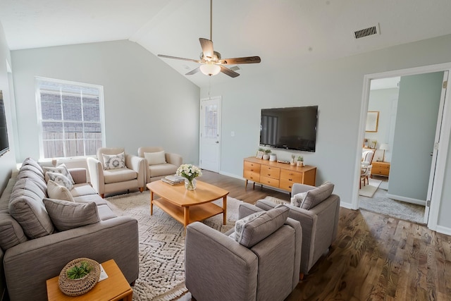 living room with wood finished floors, a ceiling fan, visible vents, and lofted ceiling