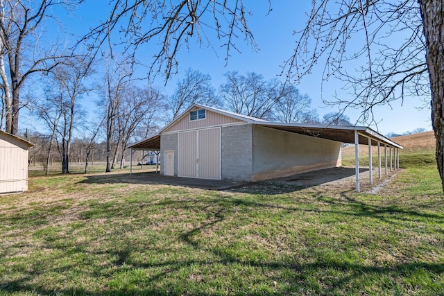 view of pole building with a lawn and a carport