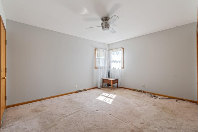 unfurnished room featuring a ceiling fan, visible vents, carpet floors, and baseboards