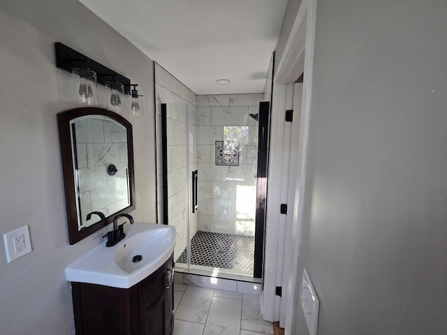 full bath with marble finish floor, a stall shower, and vanity