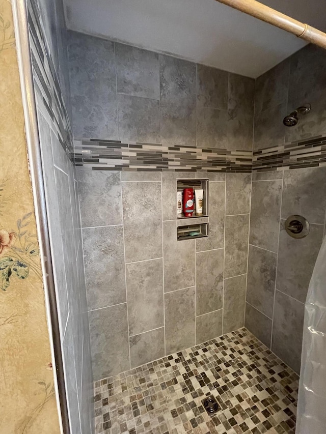 full bath with a tile shower