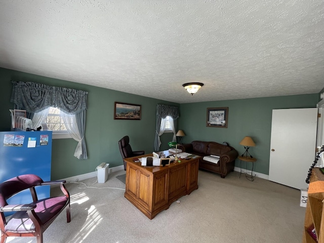 office with baseboards, a healthy amount of sunlight, and light carpet