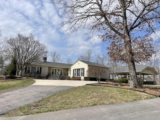 ranch-style house featuring french doors, driveway, a front lawn, and a chimney