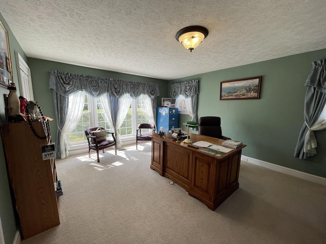 home office with baseboards, light colored carpet, and a textured ceiling