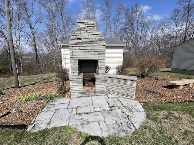 view of patio / terrace with exterior fireplace