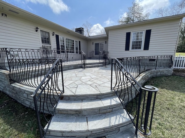 wooden terrace featuring a patio and fence