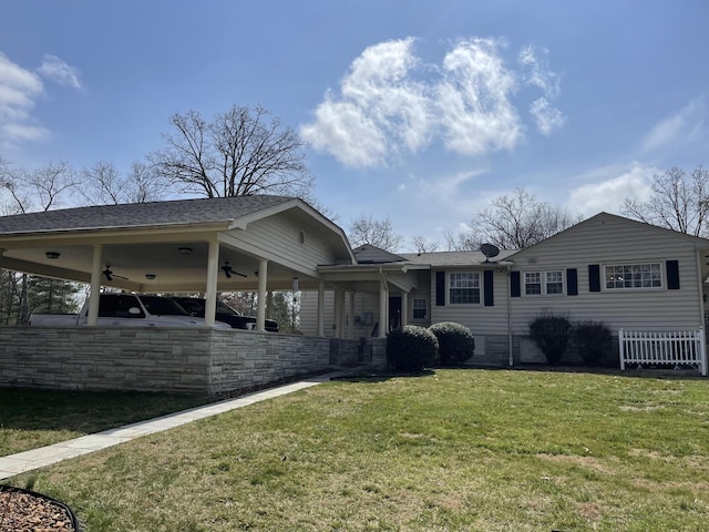 back of property featuring a lawn and ceiling fan